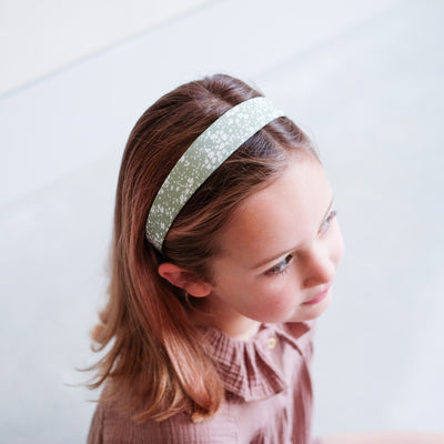 Little girl wearing pretty floral Alice band