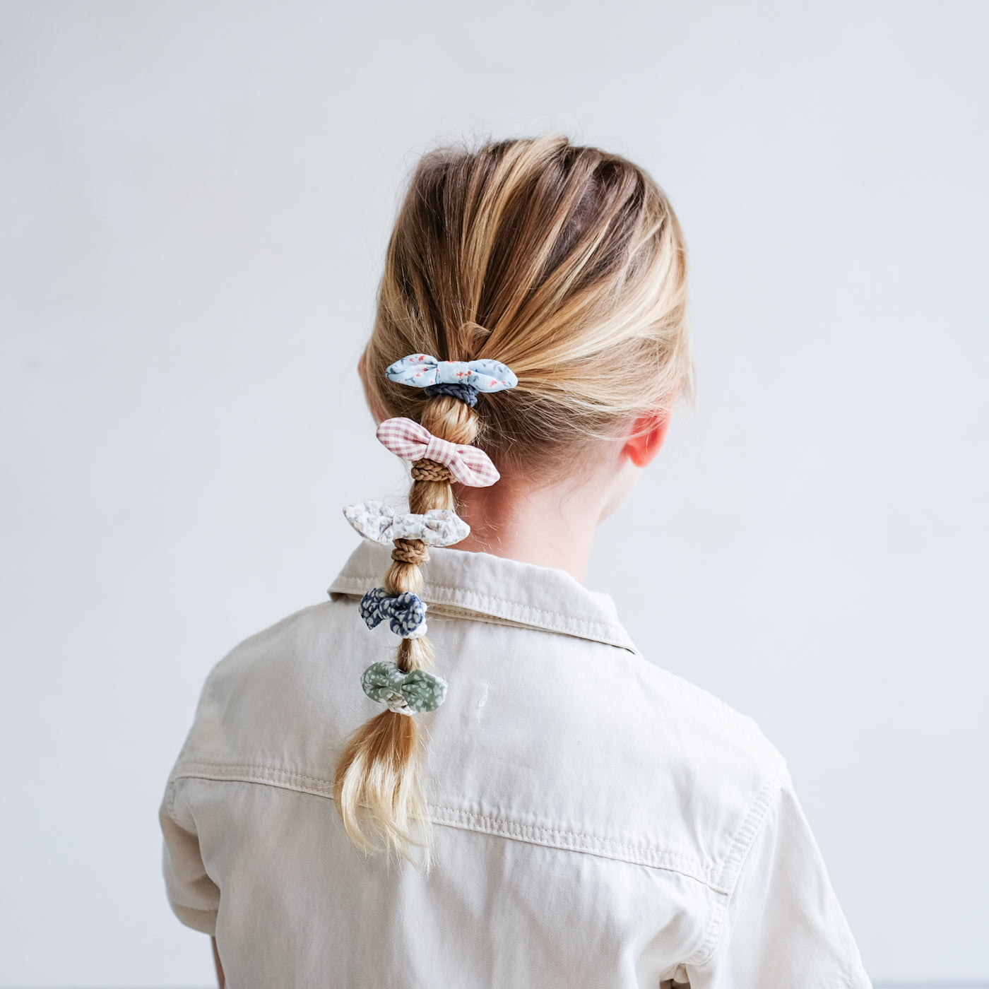 Blonde little girl with bubble ponytail, featuring pretty floral fabric bow ponies