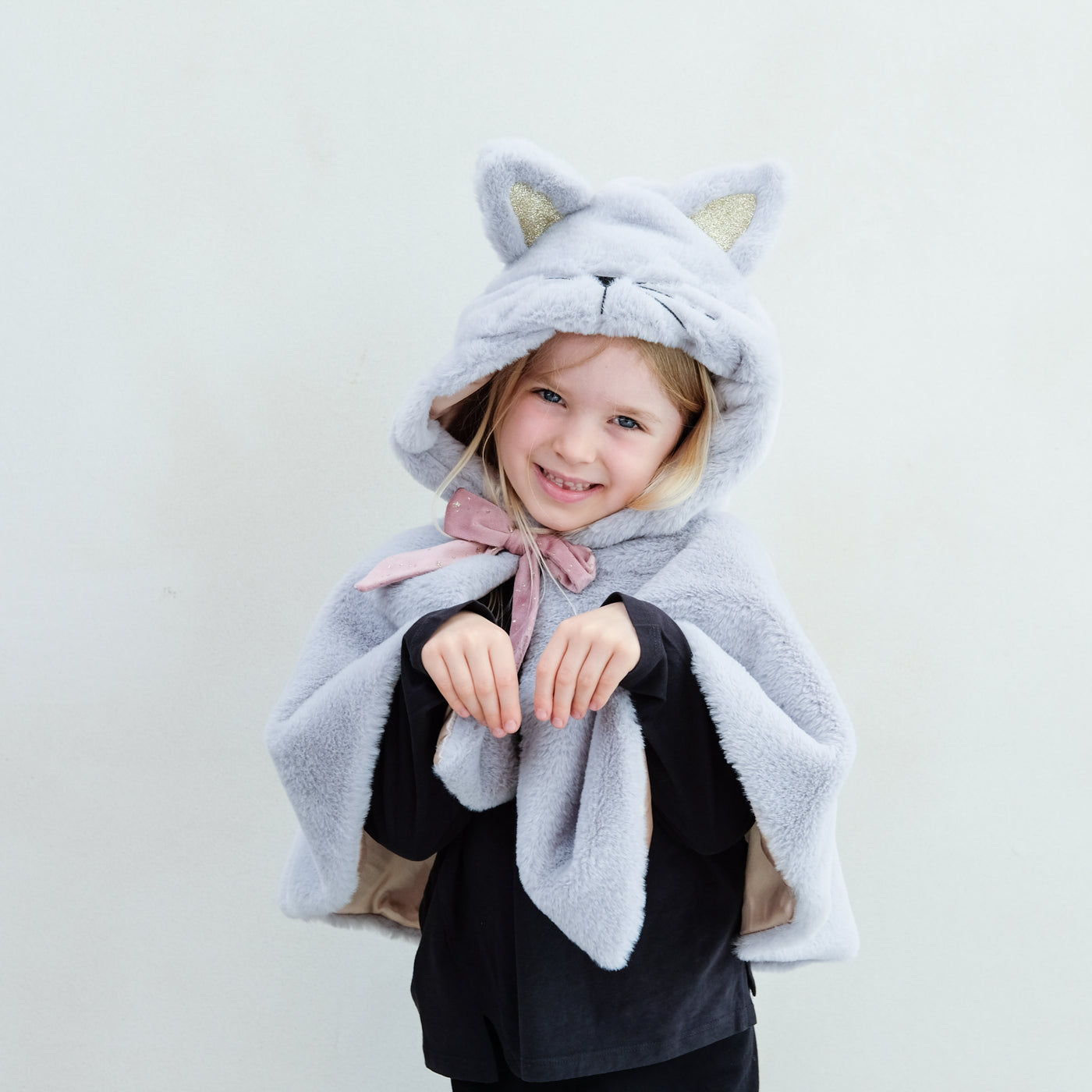 Little girl wearing hooded furry grey cat cape with pink velvet bow and gold glitter ears, complete with furry tail and satin lining