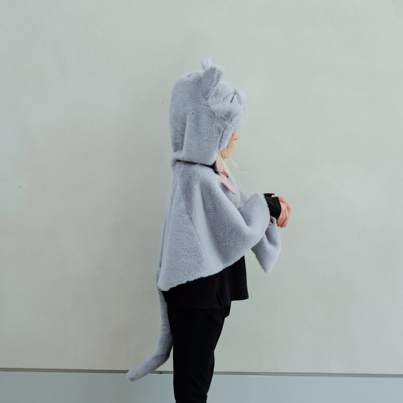 Child wearing fluffy grey cat cape with pink velvet bow and gold glitter ears