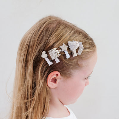 Four mini hair clips worn in dark blonde hair to the side - princess and castle theme with gold glitter