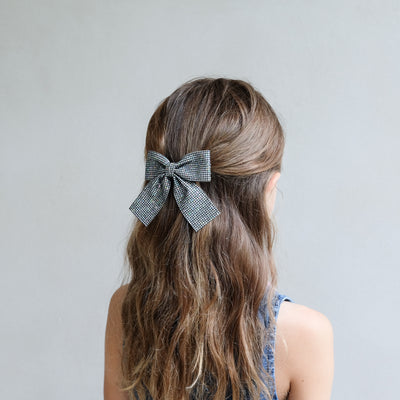 girl wearing Disco ball oversized bow in her hair against a white background