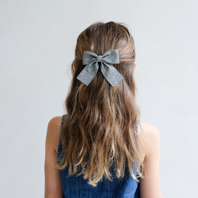 girl wearing Disco ball oversized bow in her hair against a white background