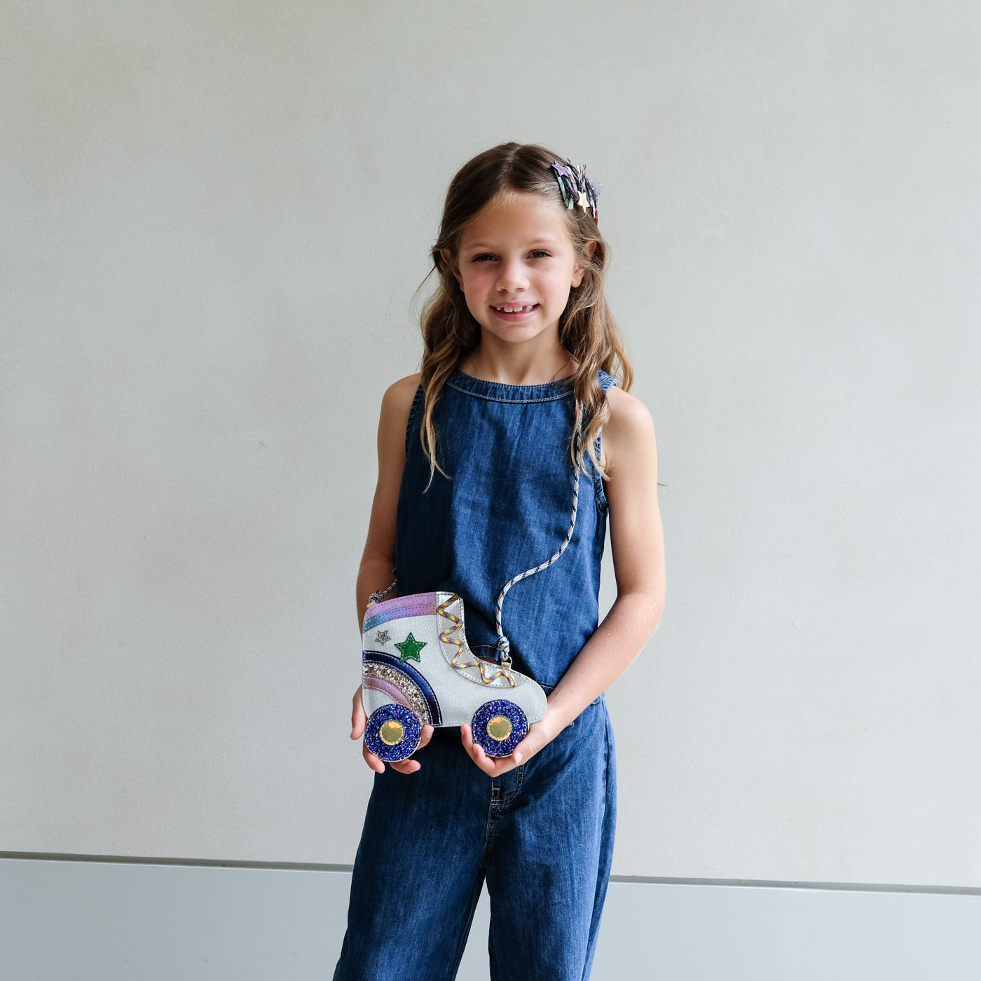 young girl wearing rollerskate novelty bag for girls against a white background