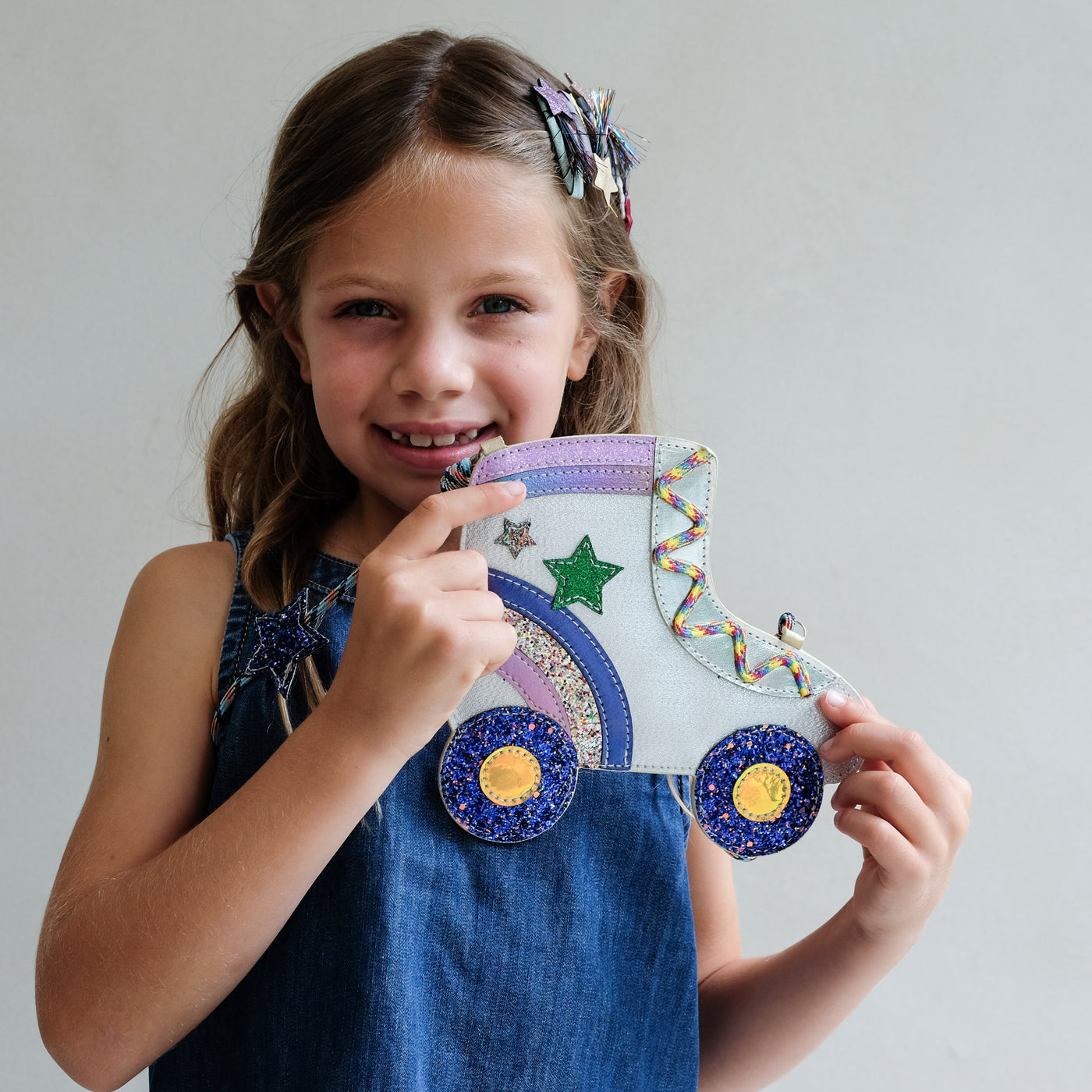 young girl wearing rollerskate novelty bag for girls against a white background