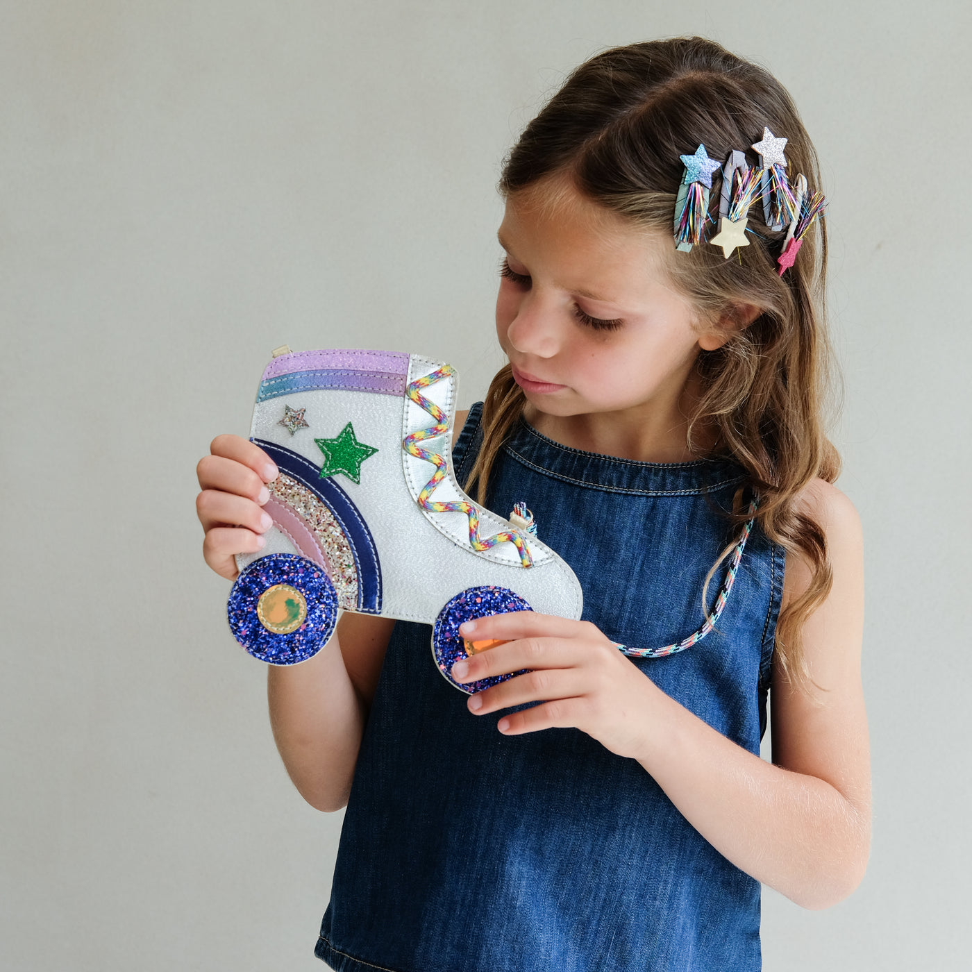 young girl wearing rollerskate novelty bag for girls against a white background