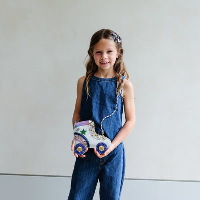 young girl wearing rollerskate novelty bag for girls against a white background