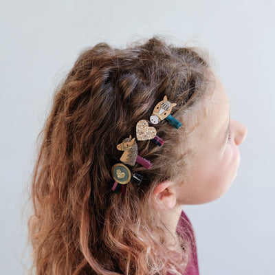 girl with curly hair wearing pony pals mini hair clips