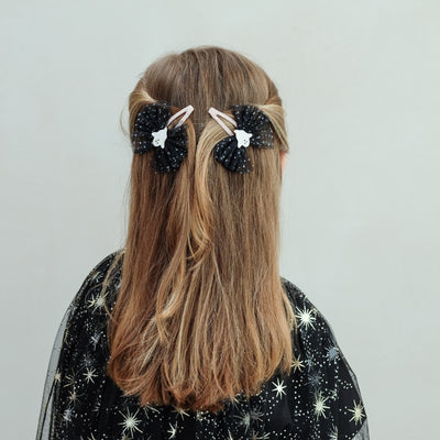 girl wearing Ghoulish ghost tulle clips in her hair against a white background