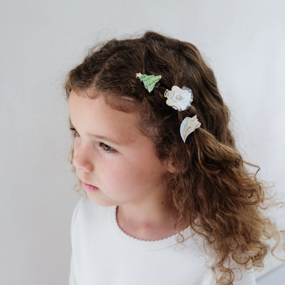 girl wearing angel mini ponies in her hair against a white background
