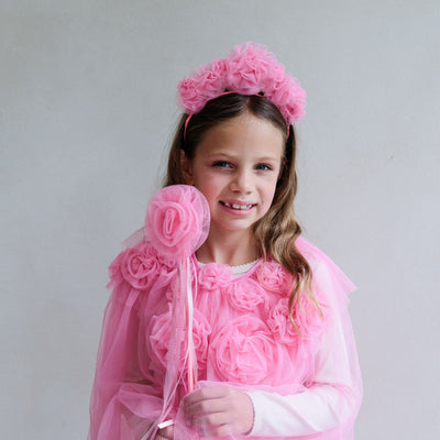Young girl in a pink floral costume with a white background