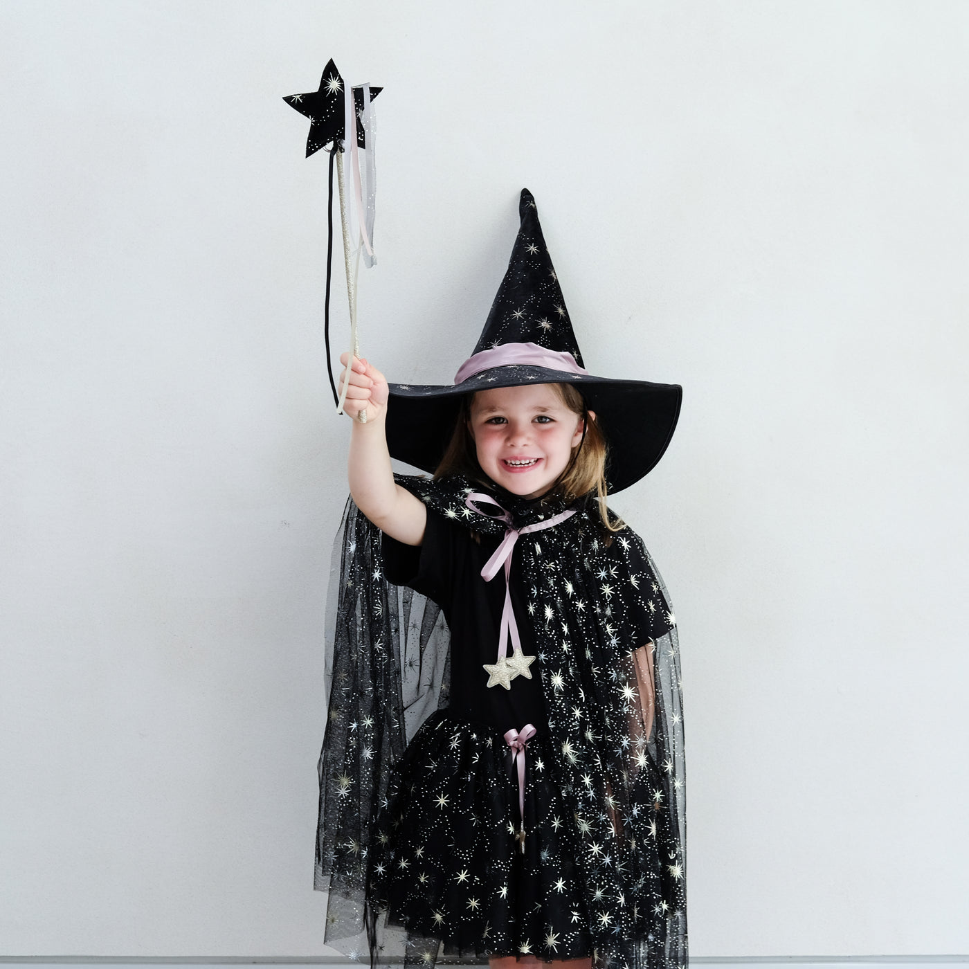 Girl wearing a black witches costume
