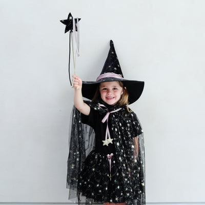 Girl wearing a black witches costume