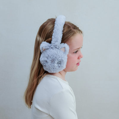 Child wearing grey fluffy cat-shaped ear muffs against a plain background