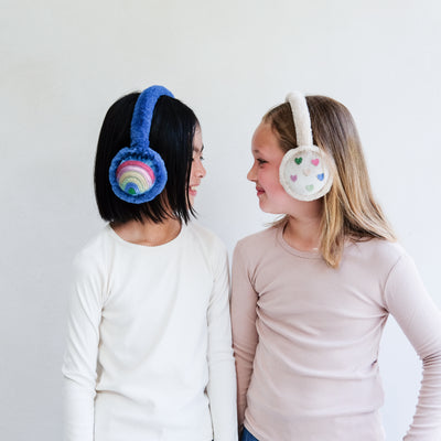 Two children wearing colourful earmuffs against a white background