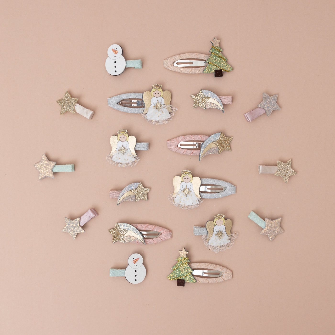 Assortment of Christmas themed glitter hair clips with soft pinks including snowmen, trees, angels and stars
