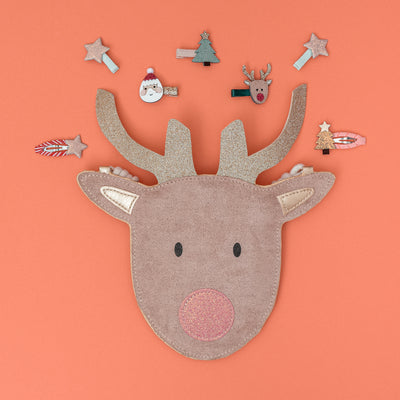 reindeer handbag on peach background surrounded by Christmas themed mini hair clips