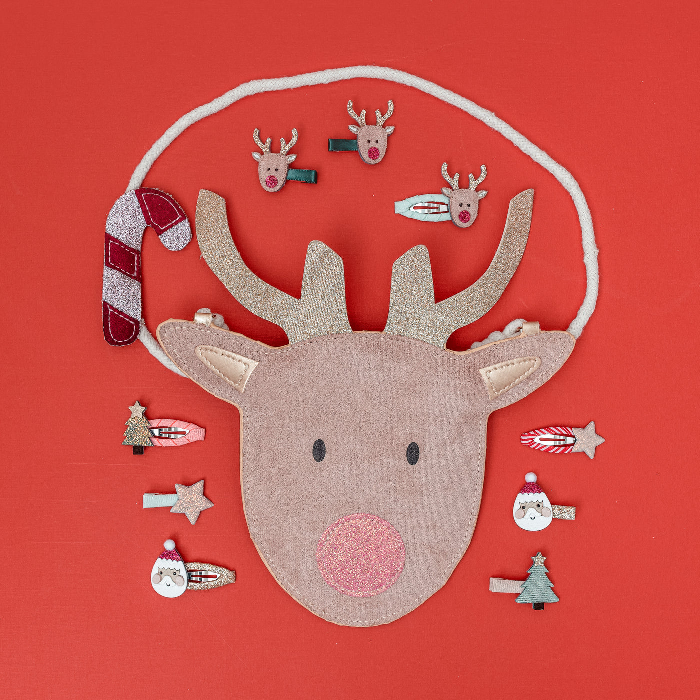reindeer handbag on red background surrounded by Christmas themed mini hair clips