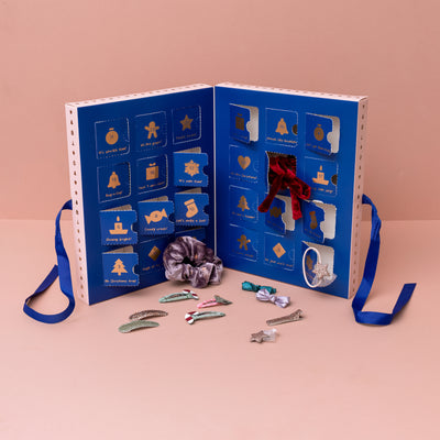 Advent calendar stood upright with doors opened showing hair accessory gifts