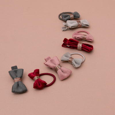 Assortment of velvet bow hair ties and clips for children in rich Christmas themed colours