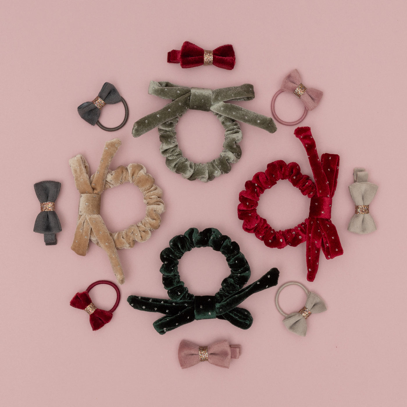 Assortment of velvet hair bands and scrunchies in rich winter colours with gold glitter details