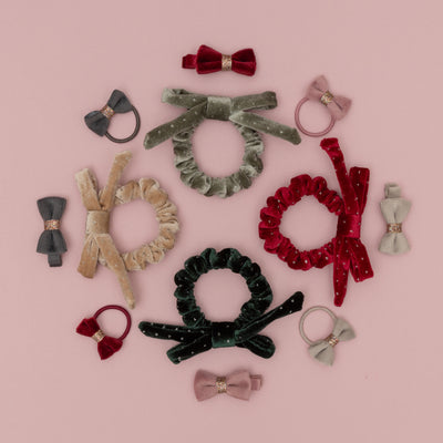 Assortment of velvet hair bands and scrunchies in rich winter colours with gold glitter details