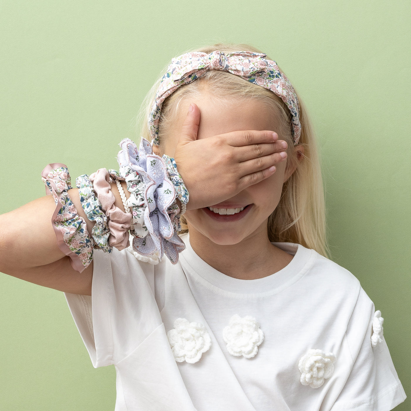 Selection of floral print scrunchies worn on the wrist