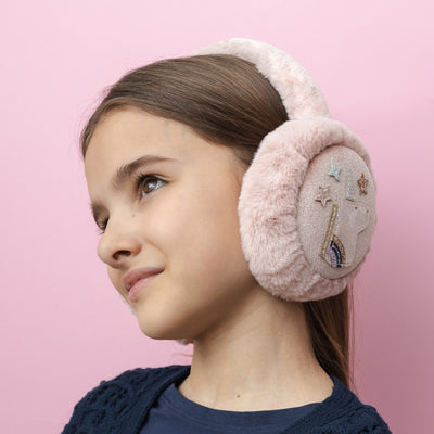 Dark haired girl looking upwards wearing Sweet pink unicorn earmuffs with soft, fluffy padding to keep little ears warm and cosy