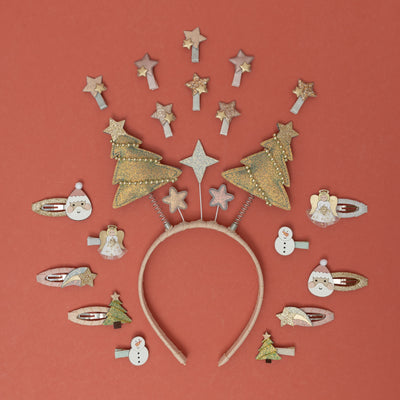 A playful Christmas tree bopper headband at the centre, surrounded by a sparkling assortment of festive holiday themed hair clips