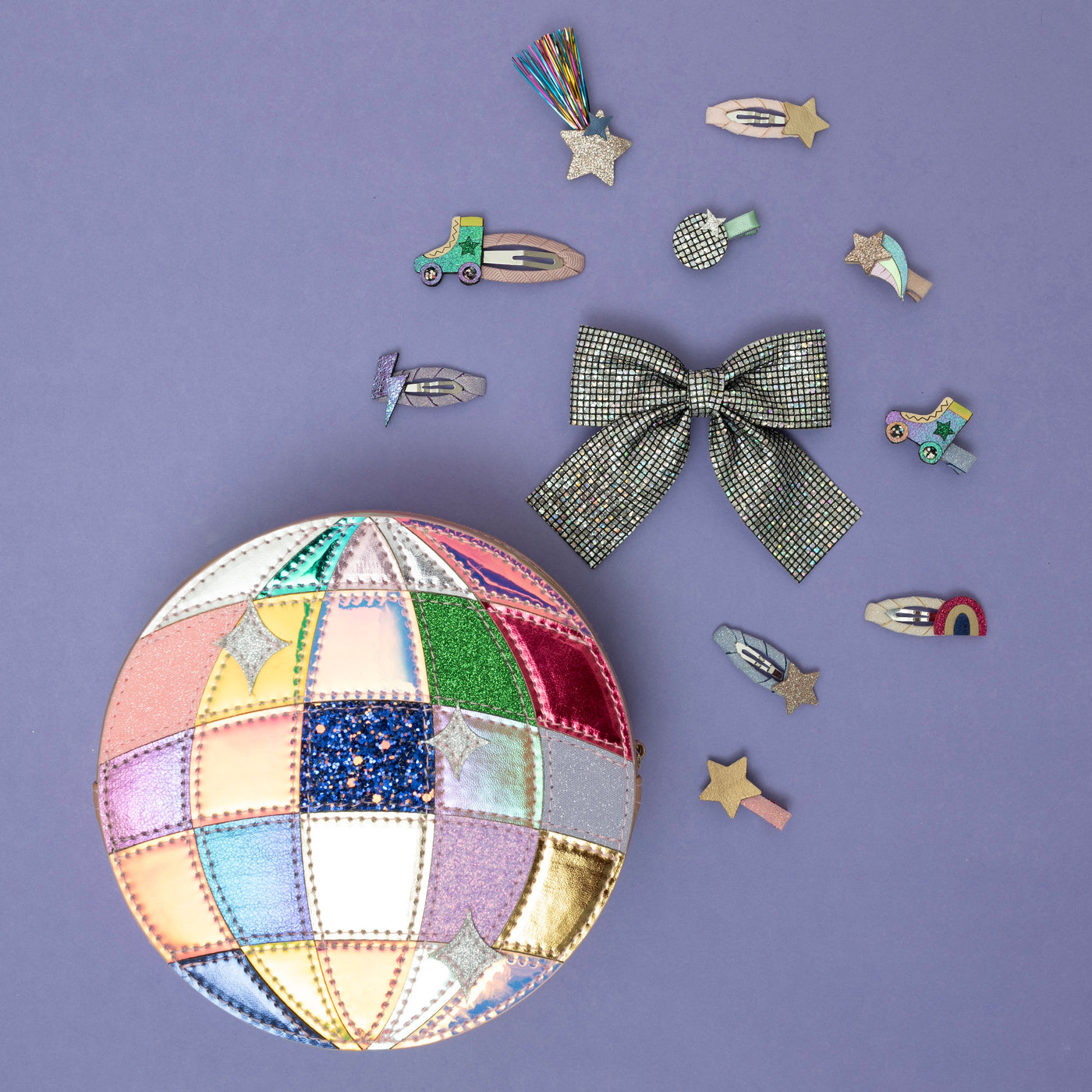 A shimmering pink round disco ball bag, surrounded by a dazzling array of vibrant, party-ready hair accessories, capturing a playful, retro-inspired vibe