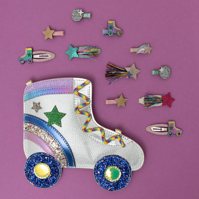 A dazzling glittery roller skate crossbody bag, shimmering with metallic sparkles and retro details like wheels and laces, surrounded by a collection of disco-themed hair clips, creating a fun, party-ready vibe