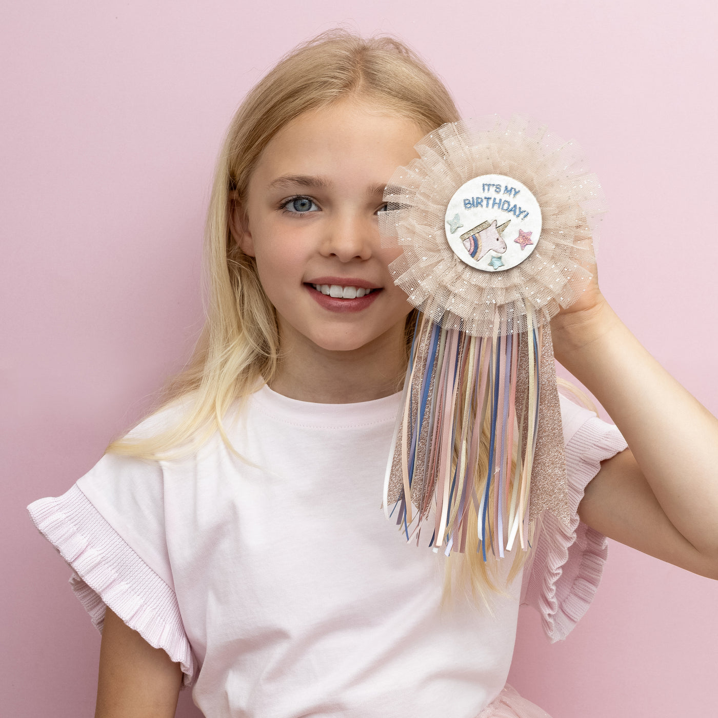 magical new unicorn birthday badge! Featuring layers of soft, glitter-speckled tulle and a colourful trail of ribbons, it’s the perfect sparkly touch for any birthday star!
