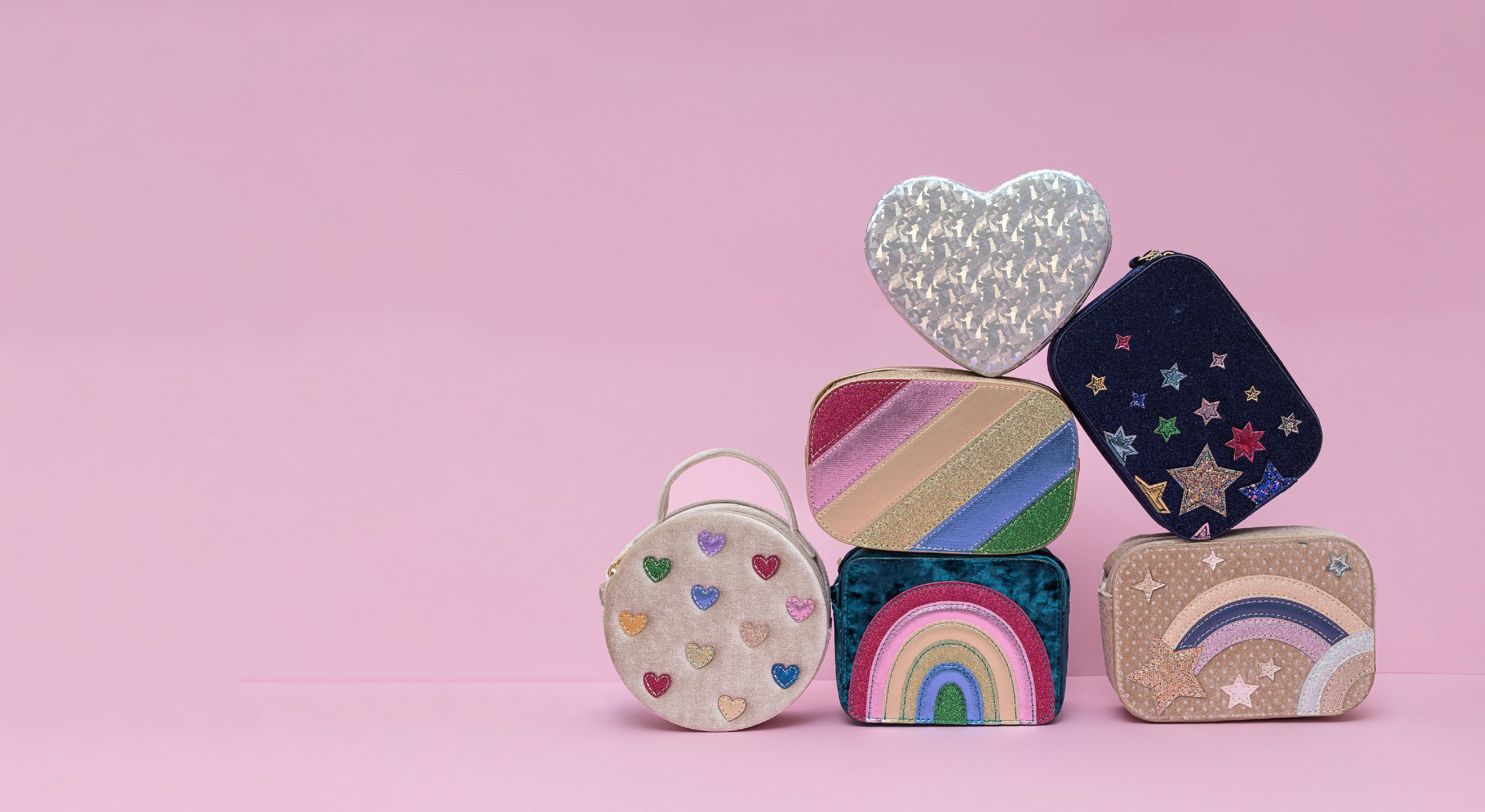 Colourful small bags with various patterns on a pink background