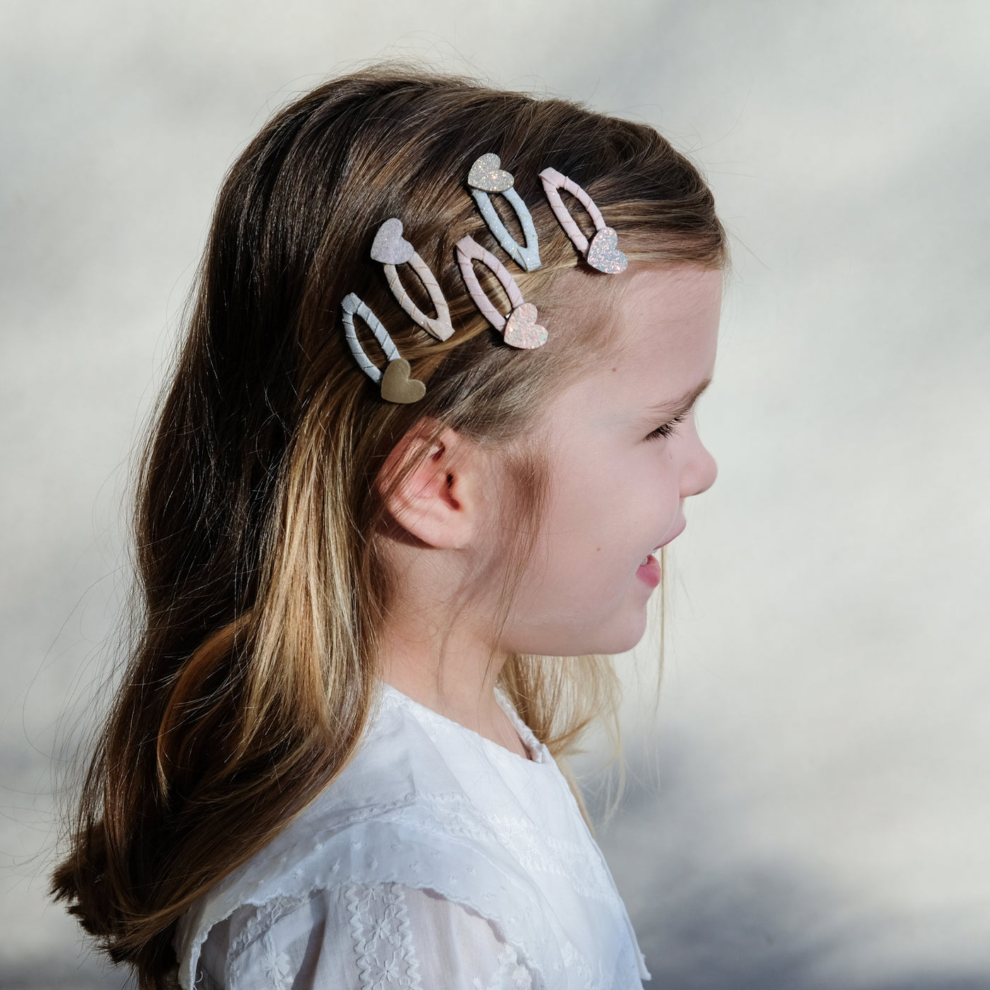 girl wearing teeny heart mini clips in her hair