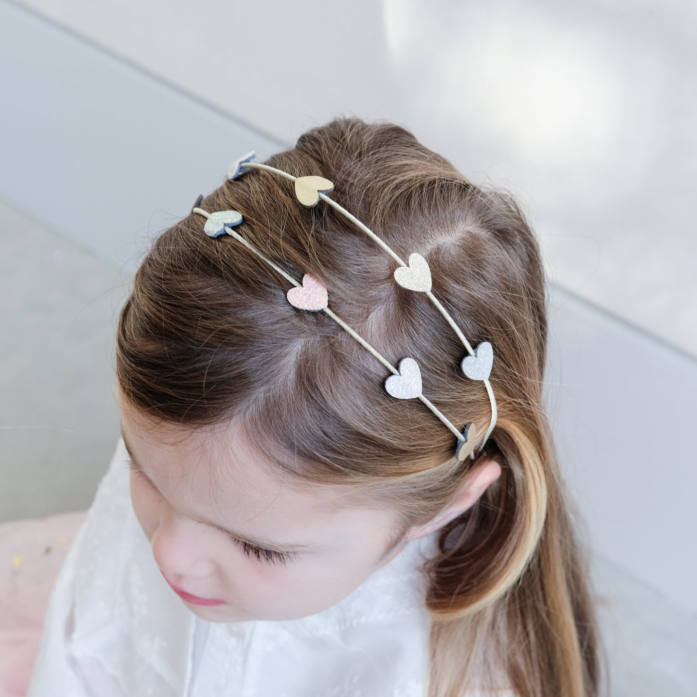 girl wearing teeny heart double alice band in her hair