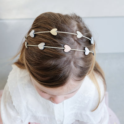 girl wearing teeny heart double alice band in her hair