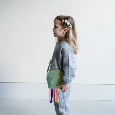 girl wearing octopus bag and matching hair clips