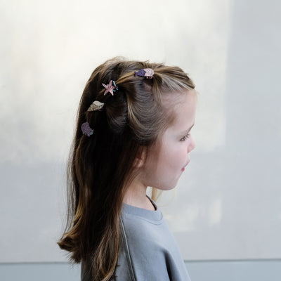 girl wearing mermaid mini ponies in her hair