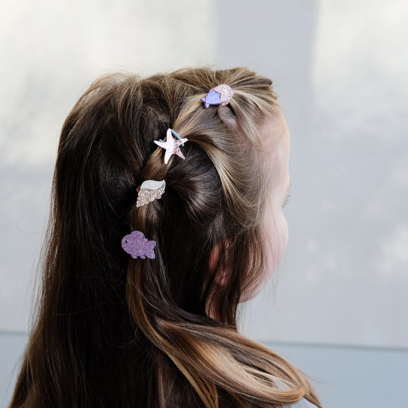 girl wearing mermaid mini ponies in her hair