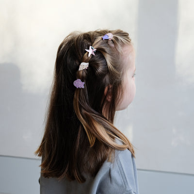 girl wearing mermaid mini ponies in her hair