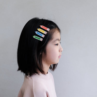 girl wearing Colouring pencil clips in hair