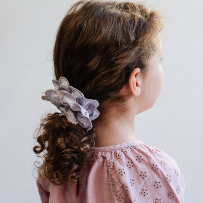 Gingham, floral print double layered scrunchie with scalloped edges worn in a ponytail