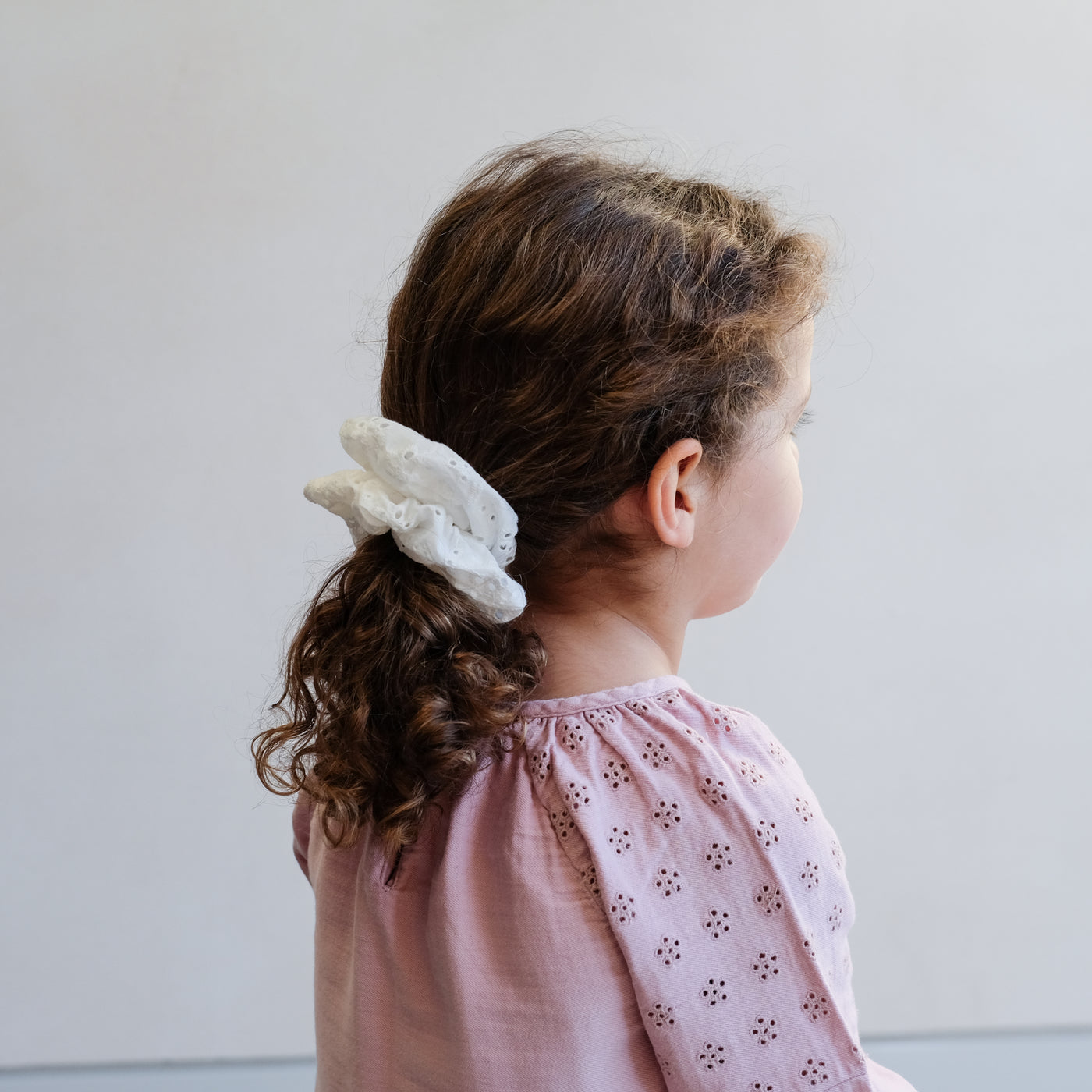 girl wearing giant broderie scrunchie in a ponytail hair style