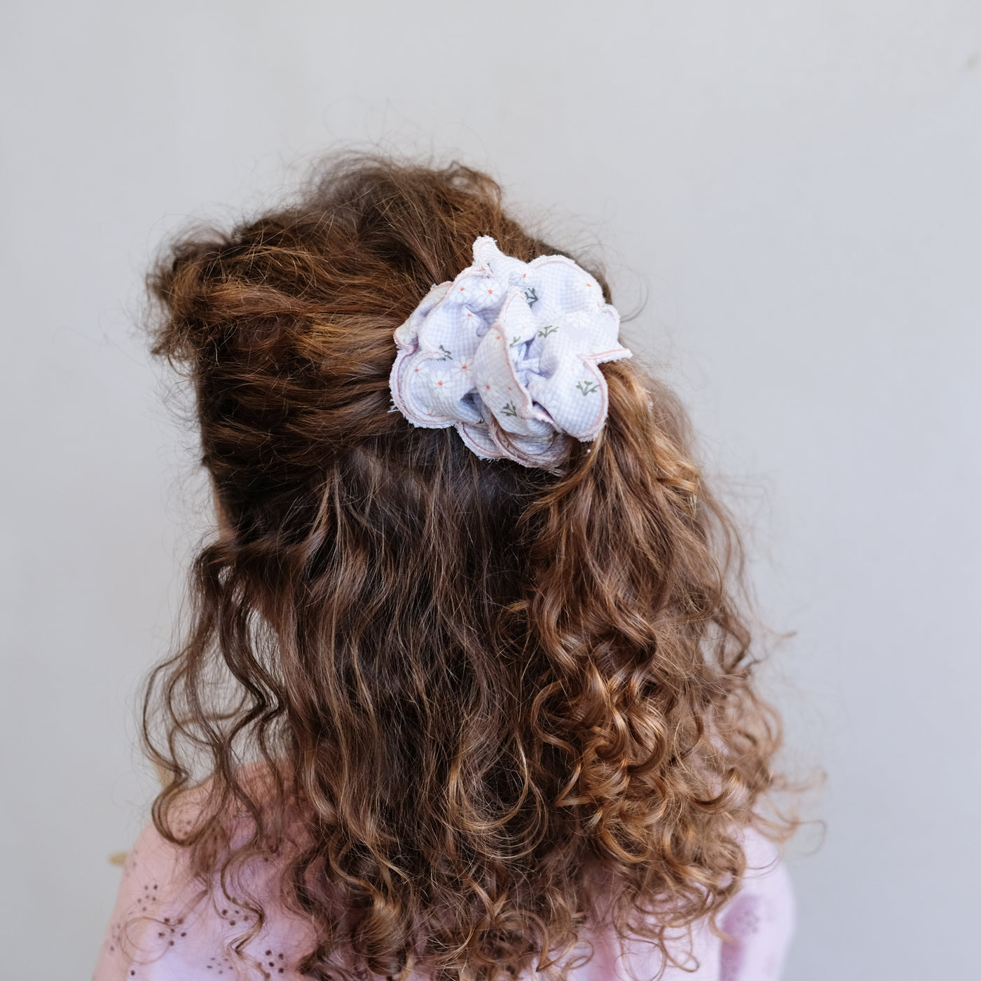 Gingham, floral print double layered scrunchie with scalloped edges worn in a part up do