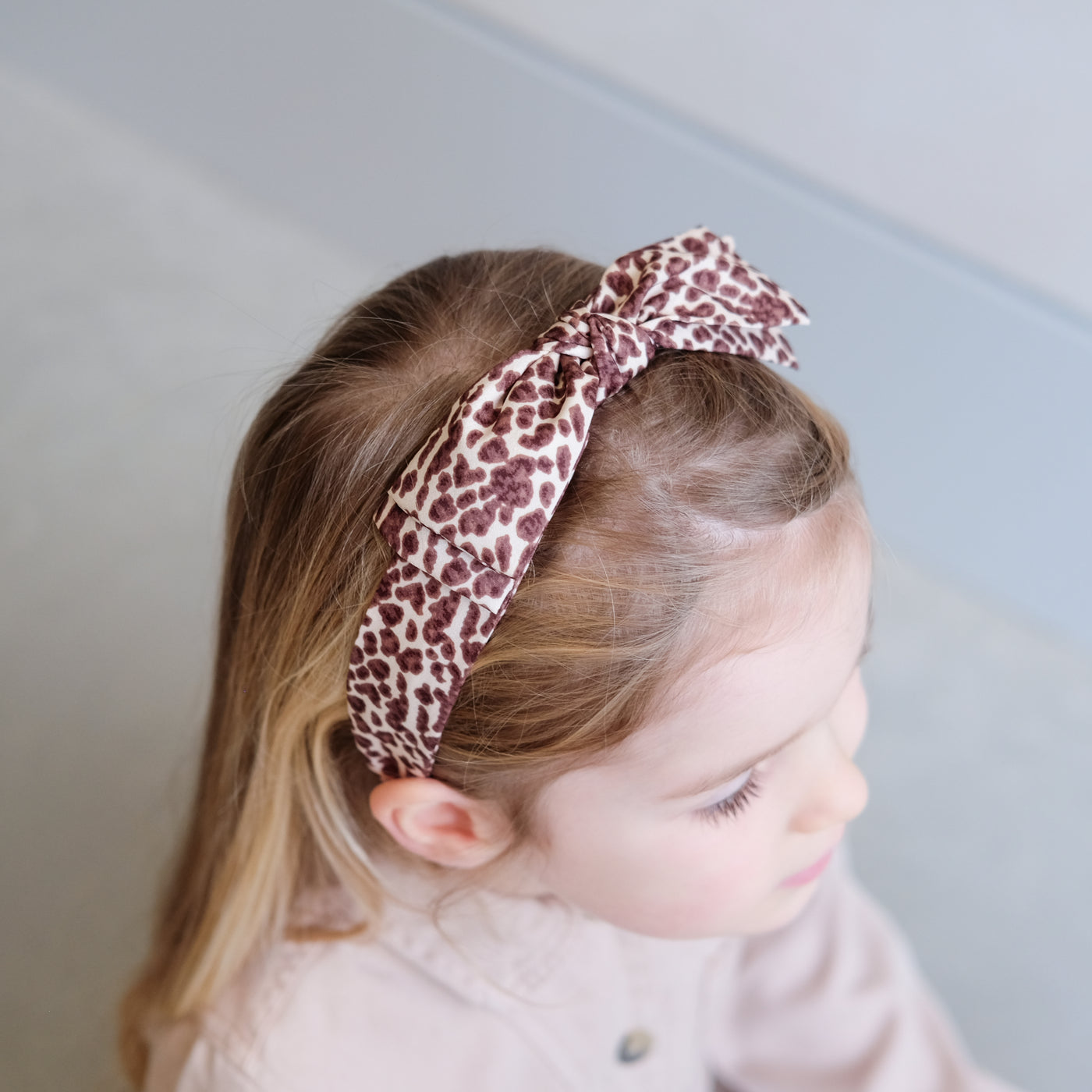 girl wearing leopard print alice band