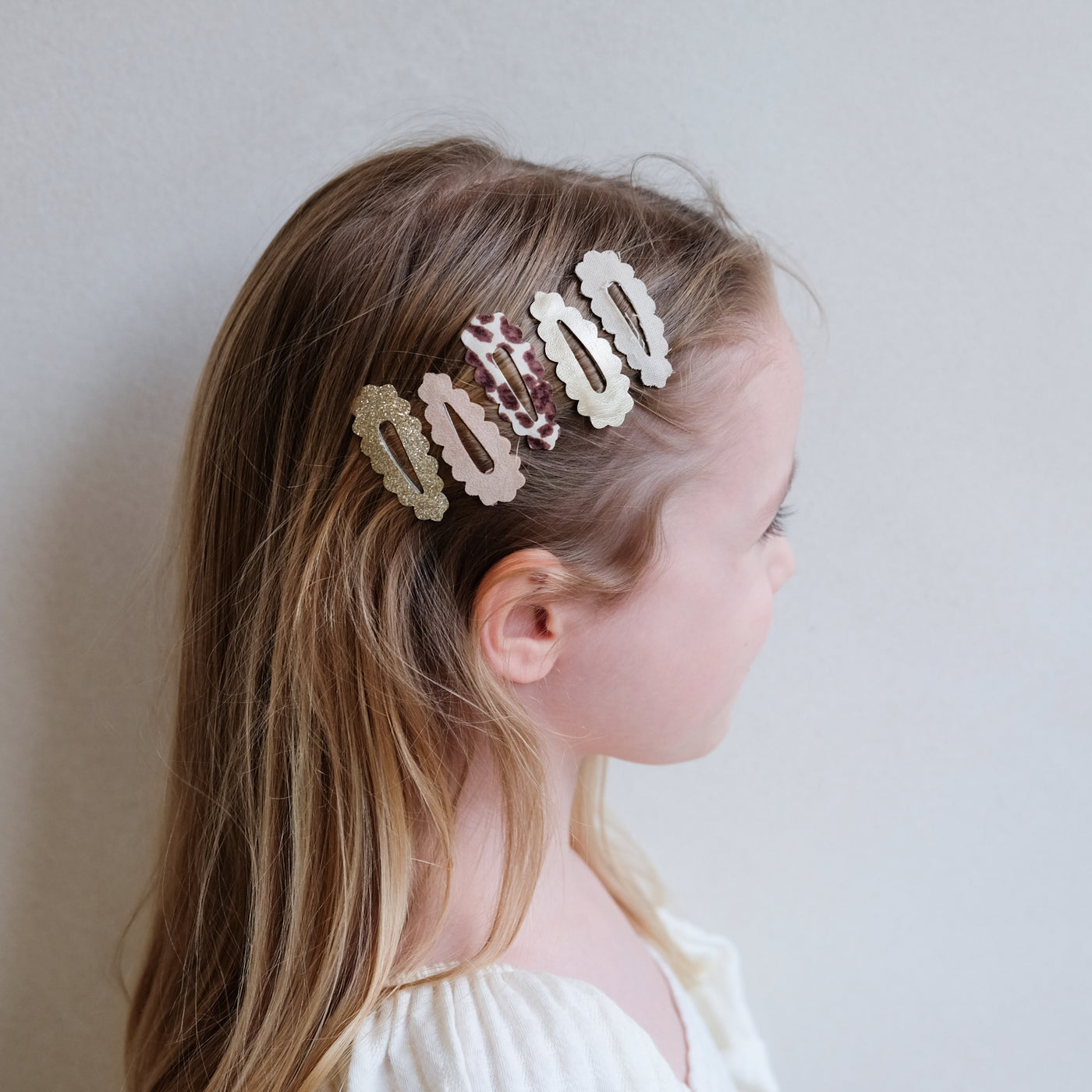 girl wearing leopard print scalloped hair clips