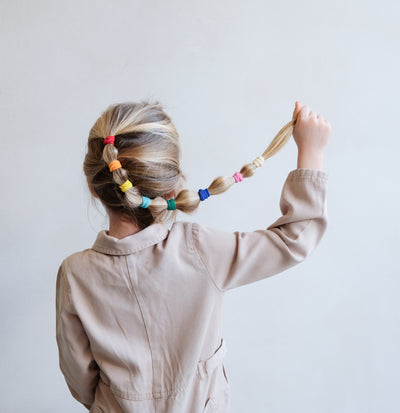 girl with rainbow bobble pony hair style using Mimi & Lula rainbow towelling ponies