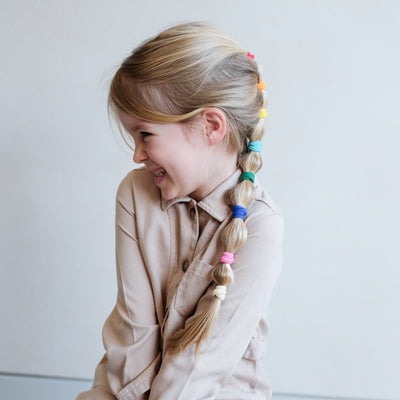 girl with rainbow bobble pony hair style using Mimi & Lula rainbow towelling ponies