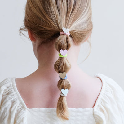 girl wearing dreamy hearts mini ponies in a bubble pony hair style