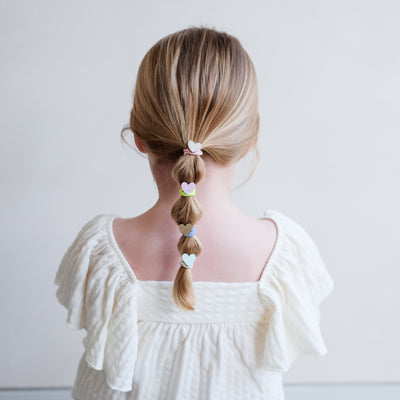 girl wearing dreamy hearts mini ponies in a bubble pony hair style